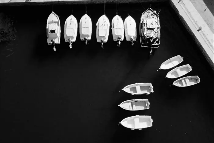 Fishing boats moored in neat rows in a harbour
